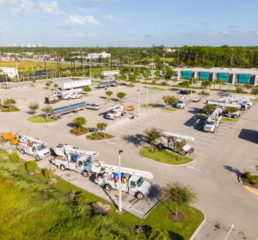 Trucks-Buckets-Liners_50-50 Several bucket trucks with their bucket arms extended and raised high in the air.